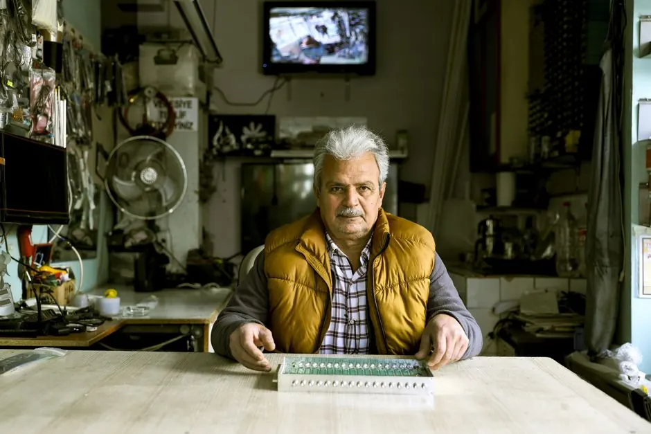Elderly man in his workshop working on electronics in Istanbul.